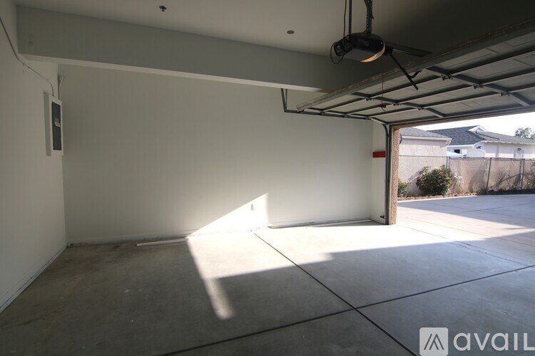 A spacious garage with a concrete floor and white walls.