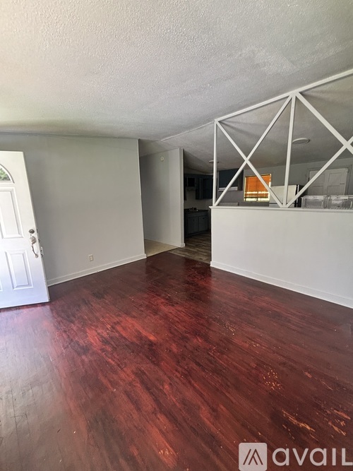 A room with wooden floors and white walls.