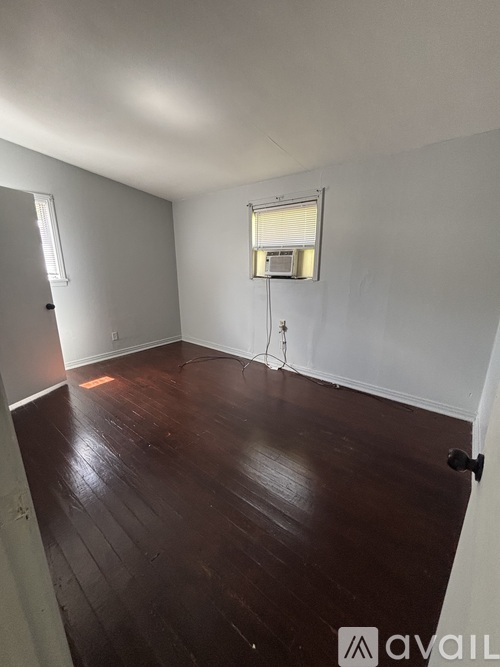 A room with wooden floors and white walls.