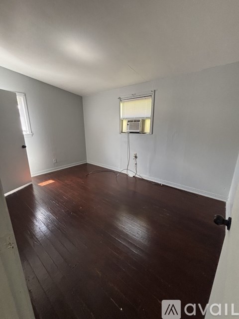 A room with wooden floors and white walls.