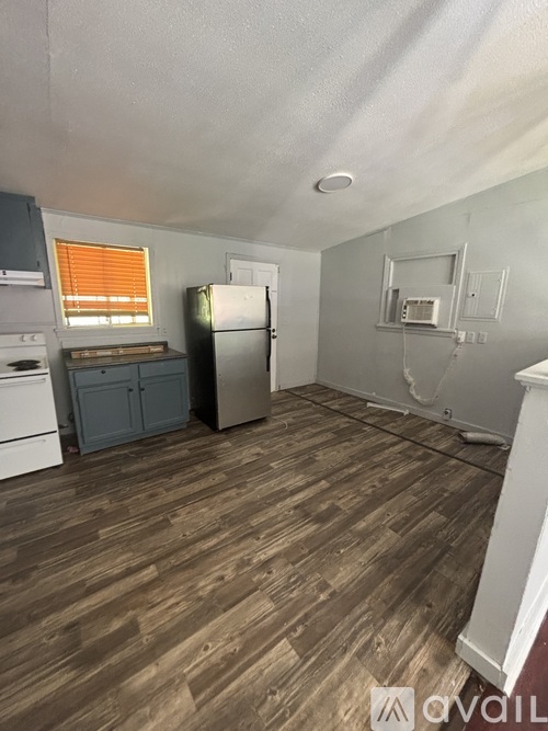 A kitchen with a refrigerator, dishwasher, and a microwave.