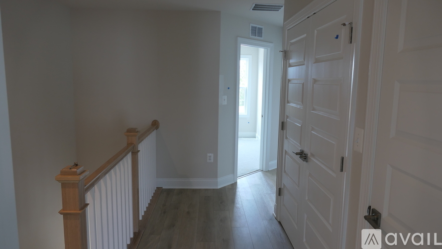 A room with a wooden staircase and a door.