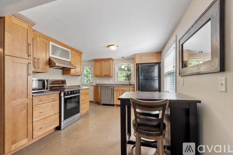 A kitchen with wooden cabinets and a black countertop.