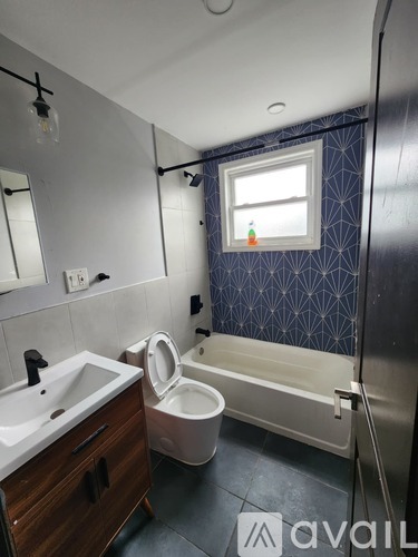 A bathroom with a toilet, sink, and bathtub.