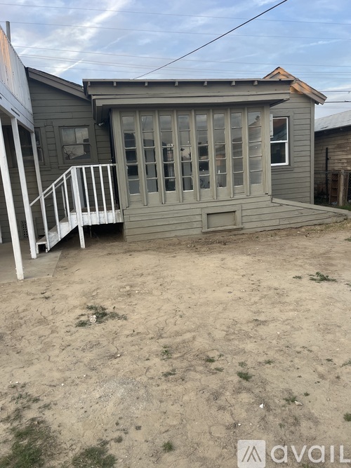A house with a grey exterior and a white porch.