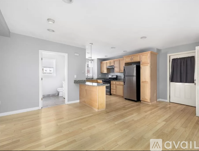 A kitchen with wooden floors and a central island.