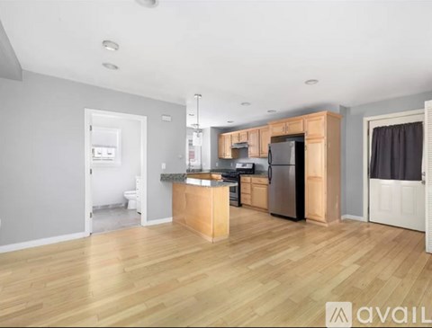 A kitchen with wooden floors and a central island.