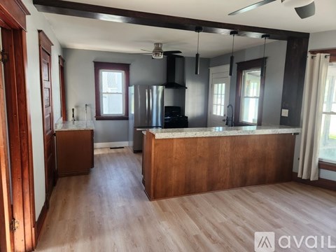 A kitchen with wooden cabinets and a black stove top oven.