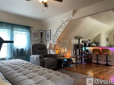 A living room with a grey sofa and a grey armchair.