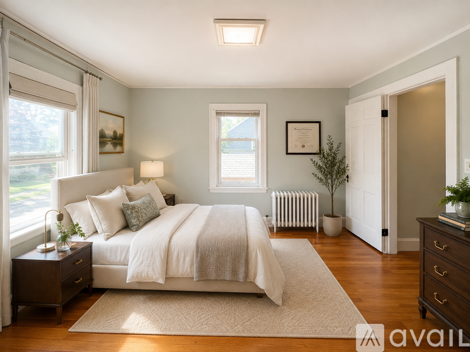 A bedroom with a large bed and a window.