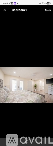 A bedroom with a large bed and a window.