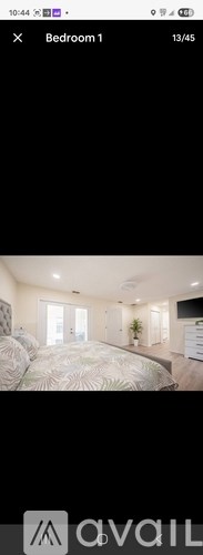 A bedroom with a large bed and a window.
