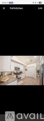 A modern kitchen with white cabinets and a central island.