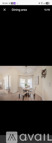 A dining area with a table and chairs is shown.