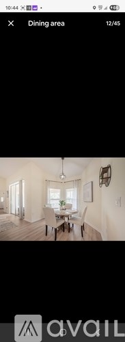 A dining area with a table and chairs is shown.
