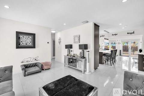 A modern living room with a black coffee table and grey sofa.