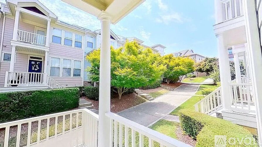 A view from a balcony overlooking a residential street.