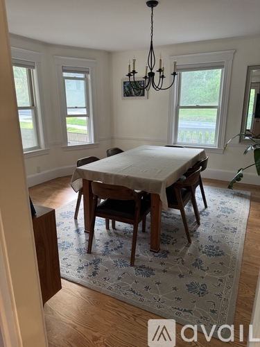 A dining room with a table and chairs.