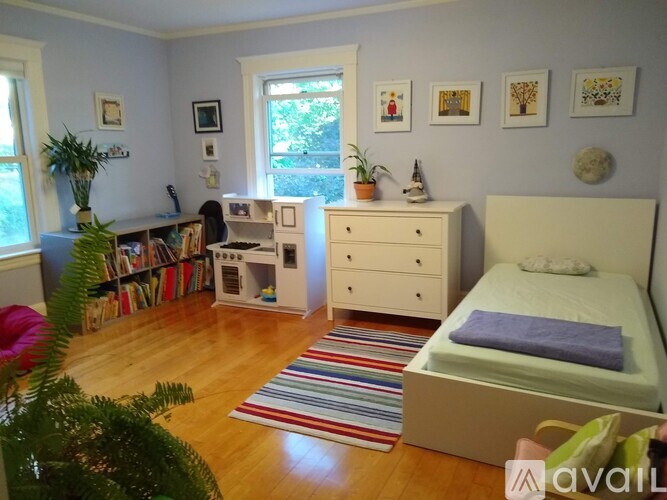 A bedroom with a bed, dresser, and bookshelf.