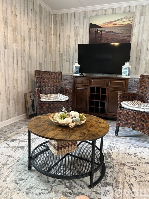 A living room with a wooden wall and a television on a cabinet.