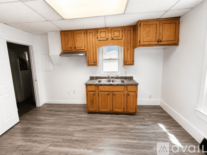 A kitchen with wooden cabinets and a countertop.