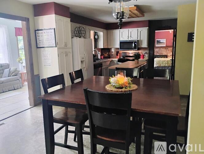 A dining room with a table set for four.