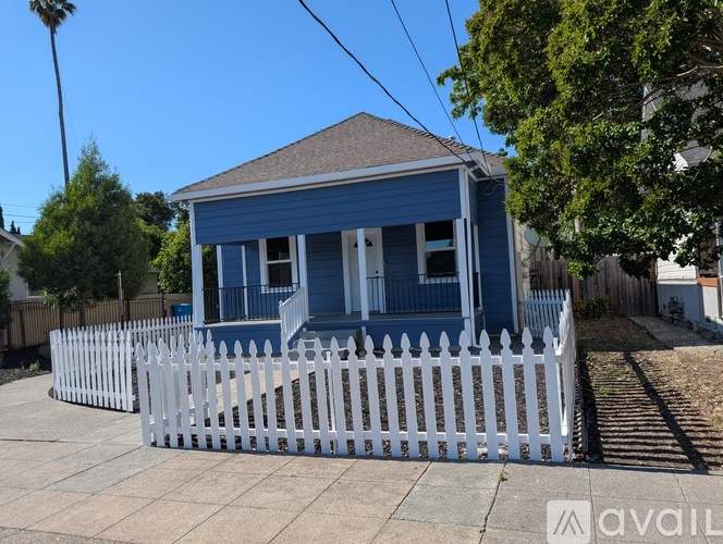 A blue house with a white picket fence.