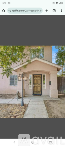 A house with a brown door and a small porch.