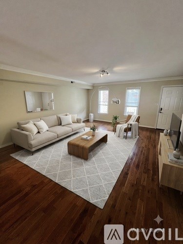 A living room with a white couch and a wooden coffee table.