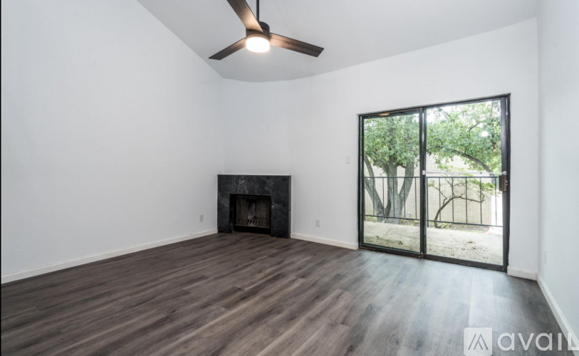 A room with a fireplace and sliding glass doors.