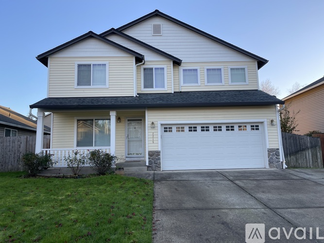 A two-story house with a garage is available for rent.