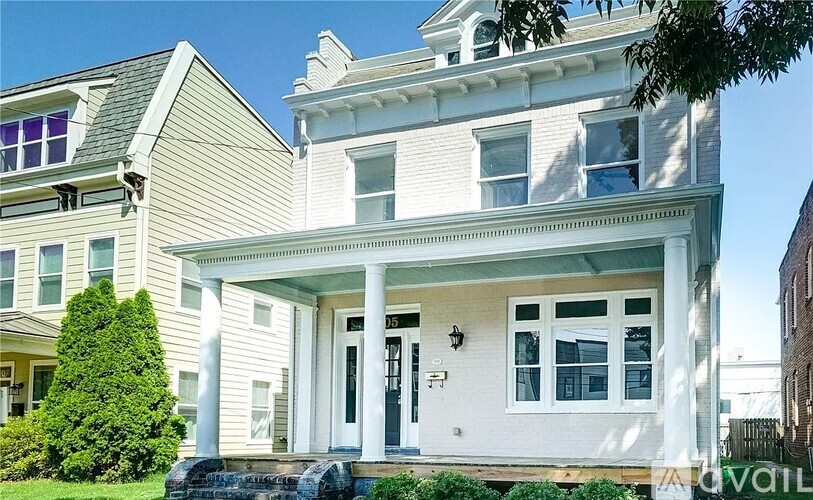 A white house with a black door and windows.