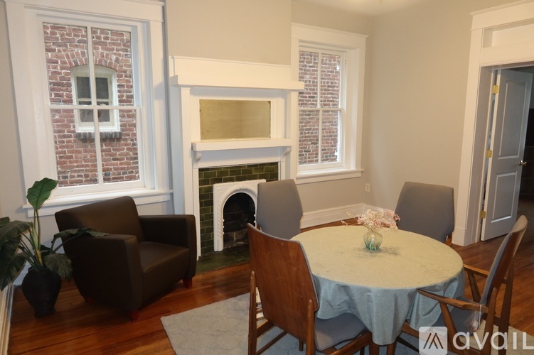 A living room with a fireplace and a dining table set up.