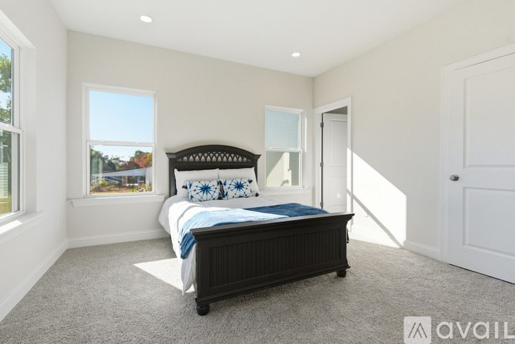 A bedroom with a large bed and a window overlooking a landscape.