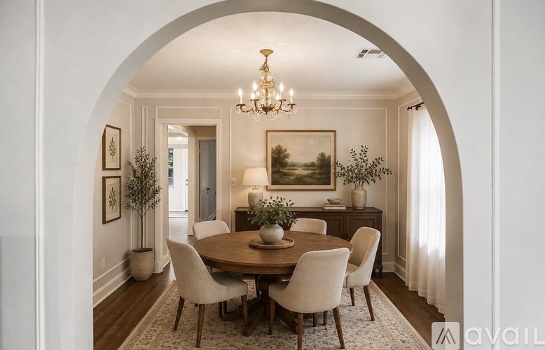 A dining room with a table set for four.