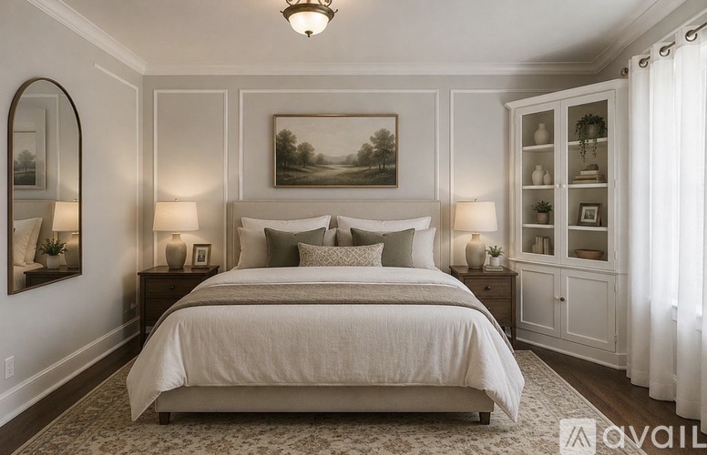 A bedroom with a large bed, a painting on the wall, and a chandelier hanging from the ceiling.