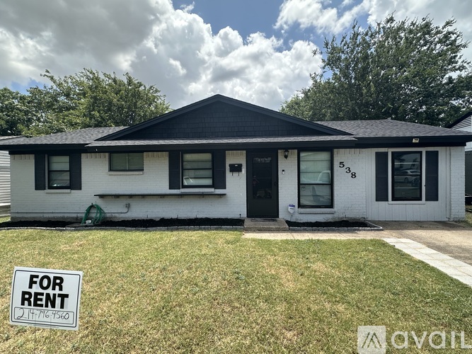 A house with a black roof and a sign that says "FOR RENT".