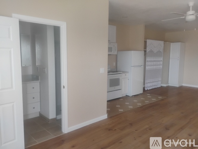 A kitchen with white appliances and cabinets is shown.