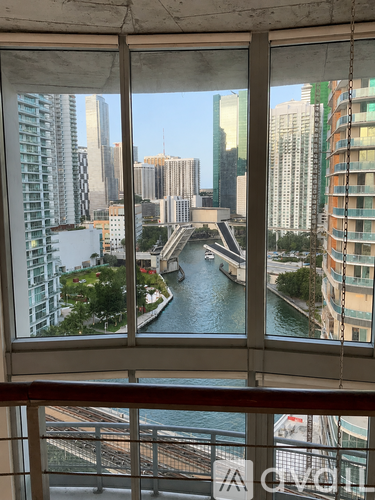 A view of a cityscape from a window overlooking a river.