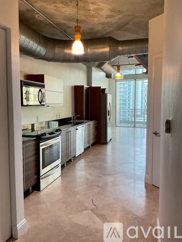 A kitchen with white cabinets and a black stove top oven.