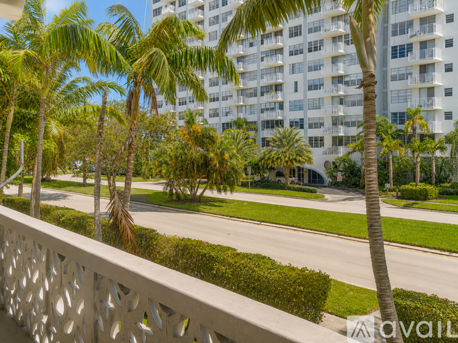 Palm trees in front of a white building.