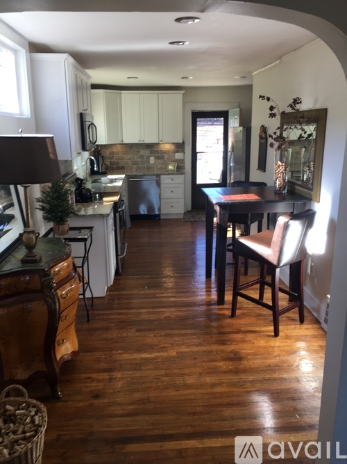 A kitchen with a table and chairs in the middle of the room.
