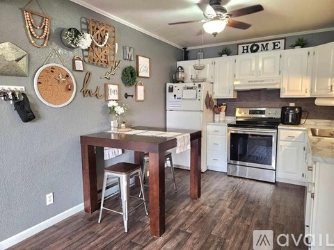 A kitchen with a table and chairs in the middle of the room.