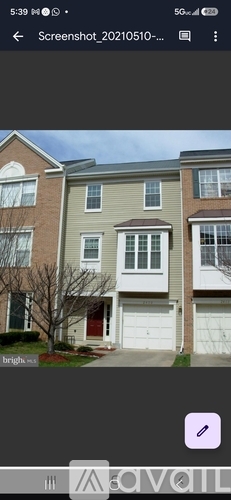 A row of houses with a tree in front of the first one.
