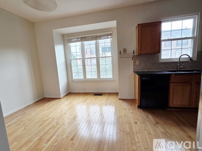 A kitchen with wooden floors and a window.