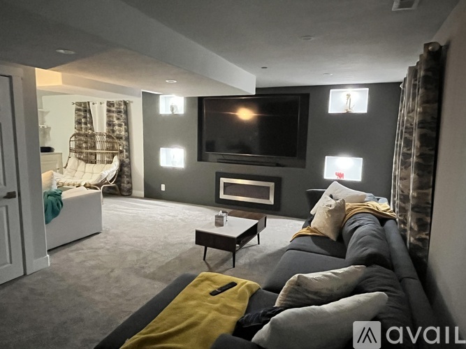A living room with a grey couch and a television.
