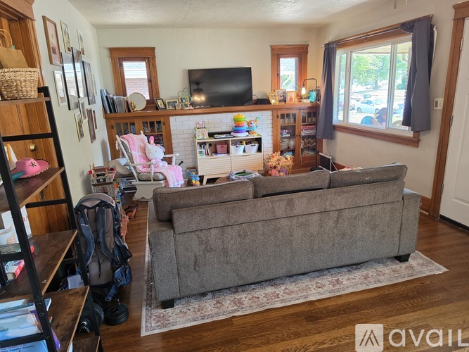 A living room with a grey couch and a television.