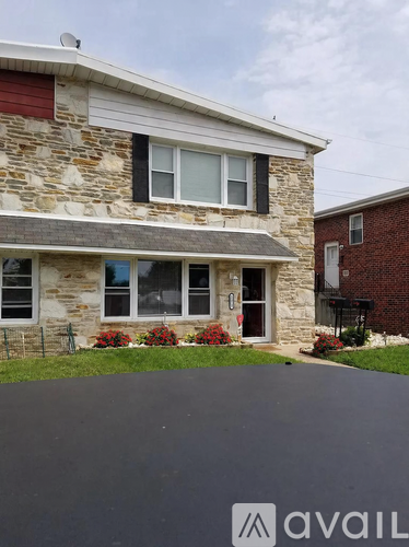 A house with a stone facade and a red roof.