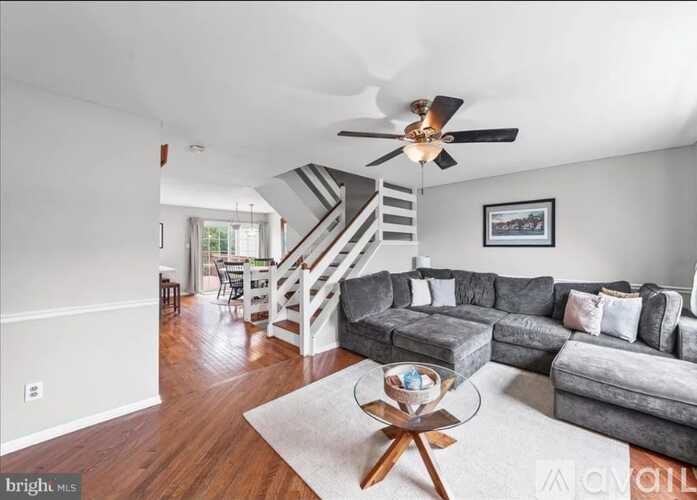 A living room with a grey couch and a wooden coffee table.