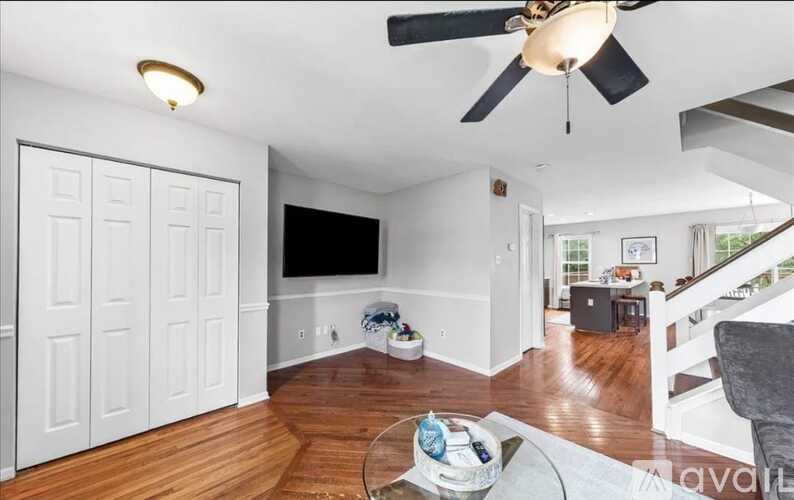 A living room with a ceiling fan and a couch.
